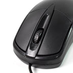 Underside view of the wired optical mouse, revealing the precise optical sensor.