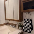Side profile of the BathNova square ABS towel ring holder, highlighting its slim design.