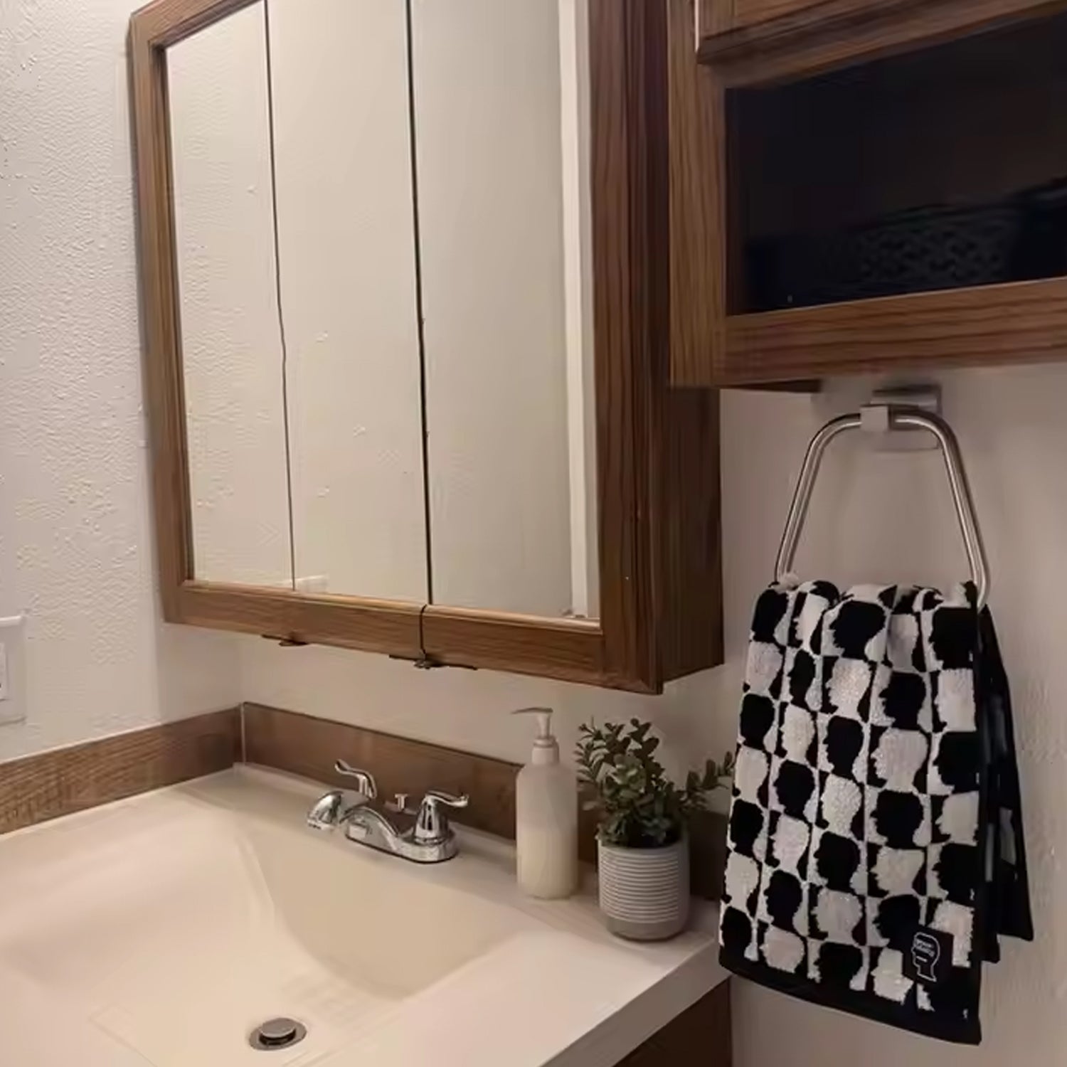 Side profile of the BathNova square ABS towel ring holder, highlighting its slim design.