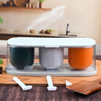 Top-down view of the 3-grid spice box kit, showcasing its clear lid and neatly arranged spoons.