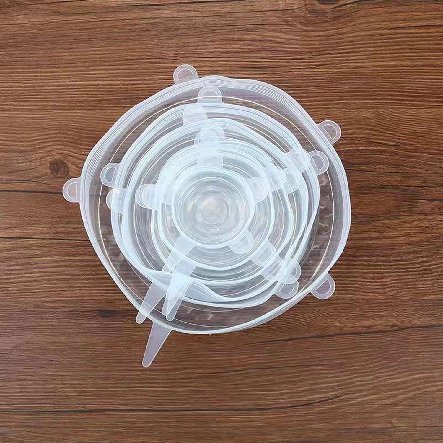 Hand stretching a flexible silicone lid to fit a large bowl.