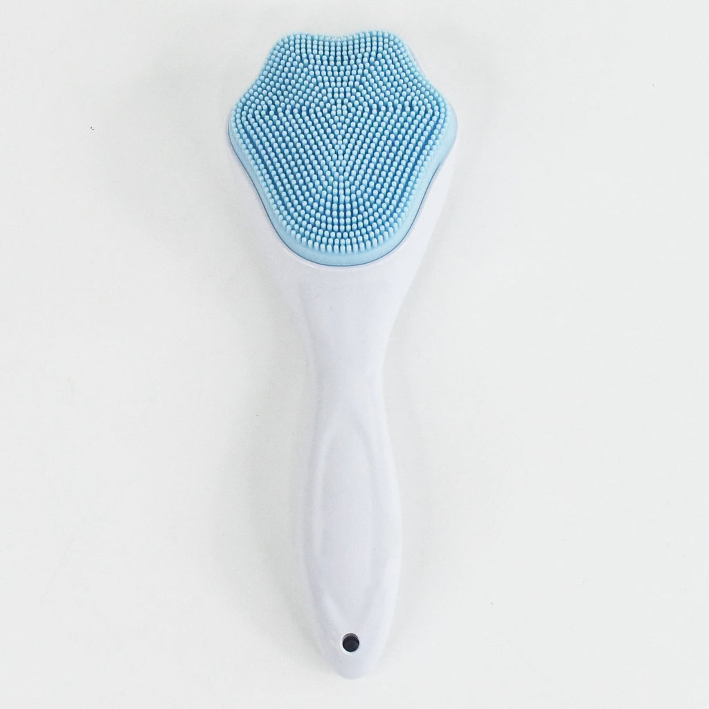 Silicone face scrubber displayed with other skincare products for a complete routine.