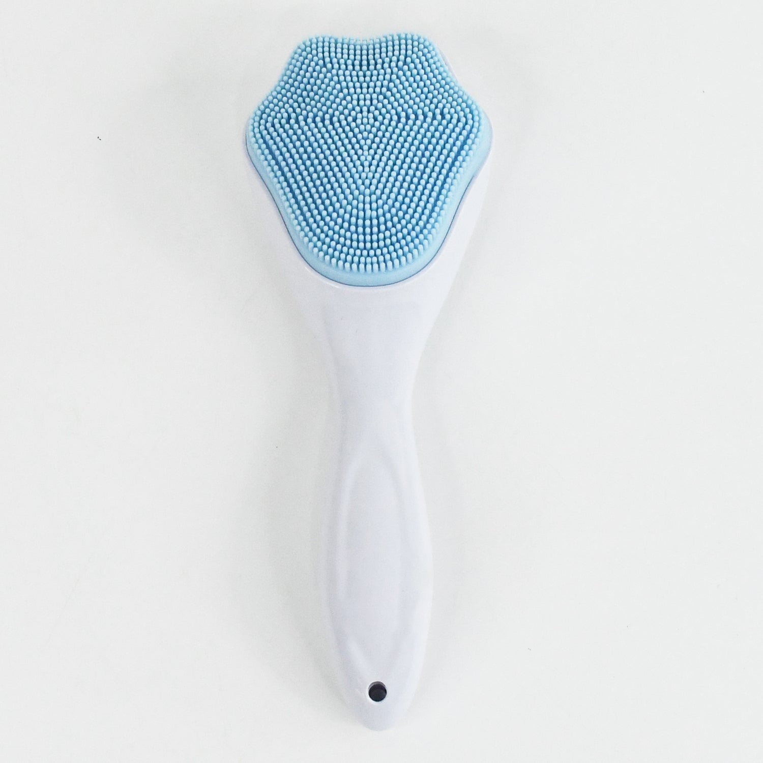 Silicone face scrubber displayed with other skincare products for a complete routine.