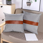 Close-up of a pair of 20x20 inch leather and cotton pillow covers