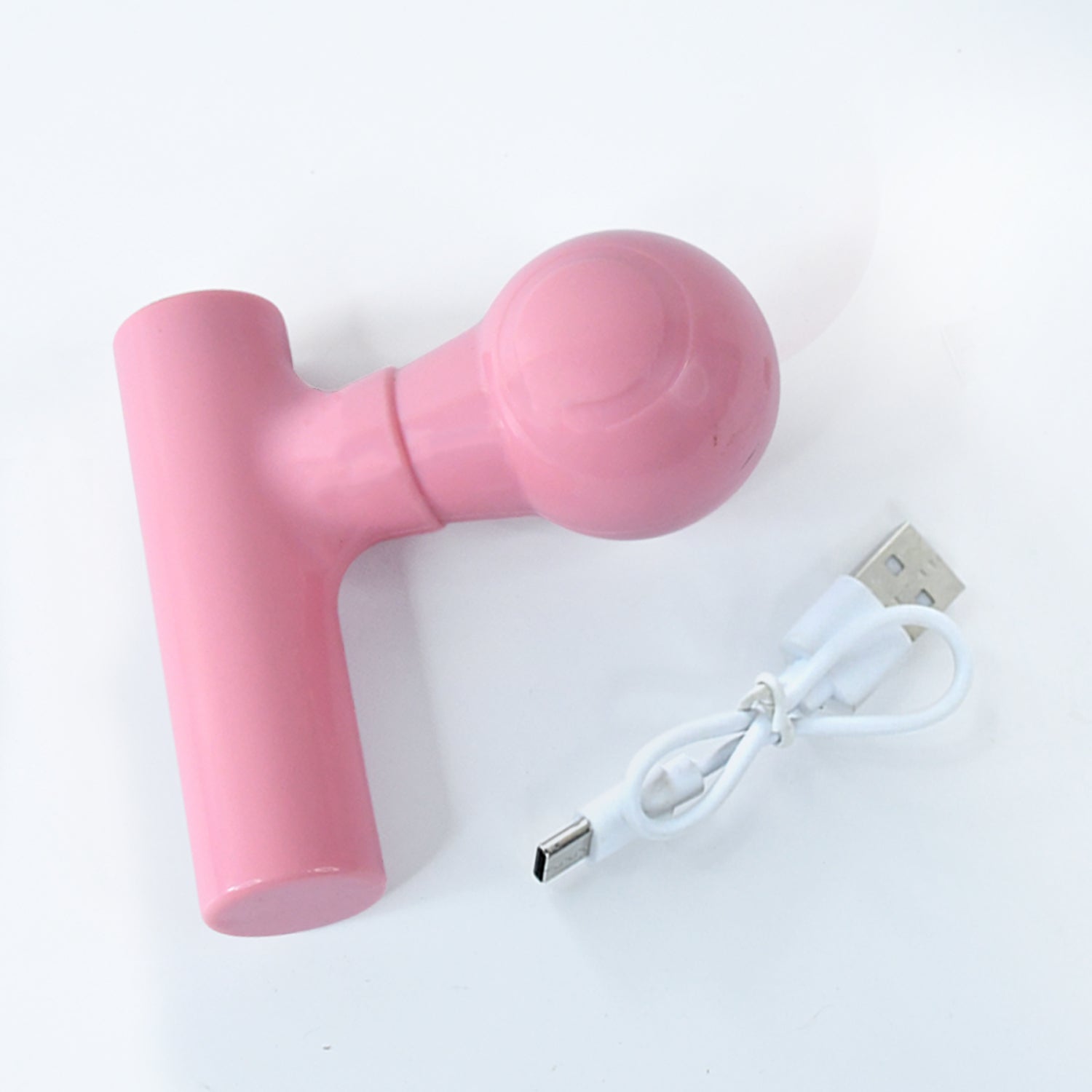 Top view of the black body massager, highlighting its simple button.