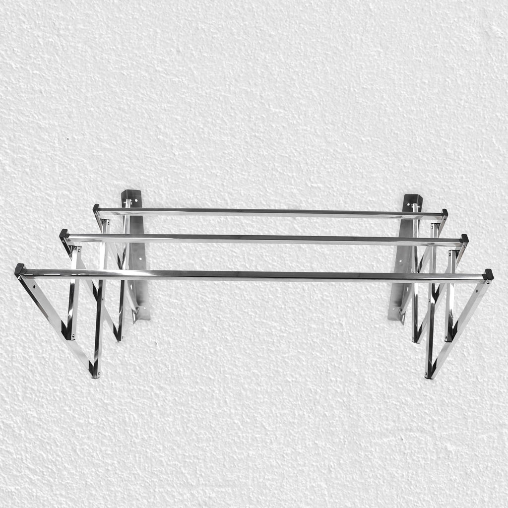 Close-up of wall-mounted stainless steel folding drying rack fully extended