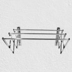 Close-up of wall-mounted stainless steel folding drying rack fully extended