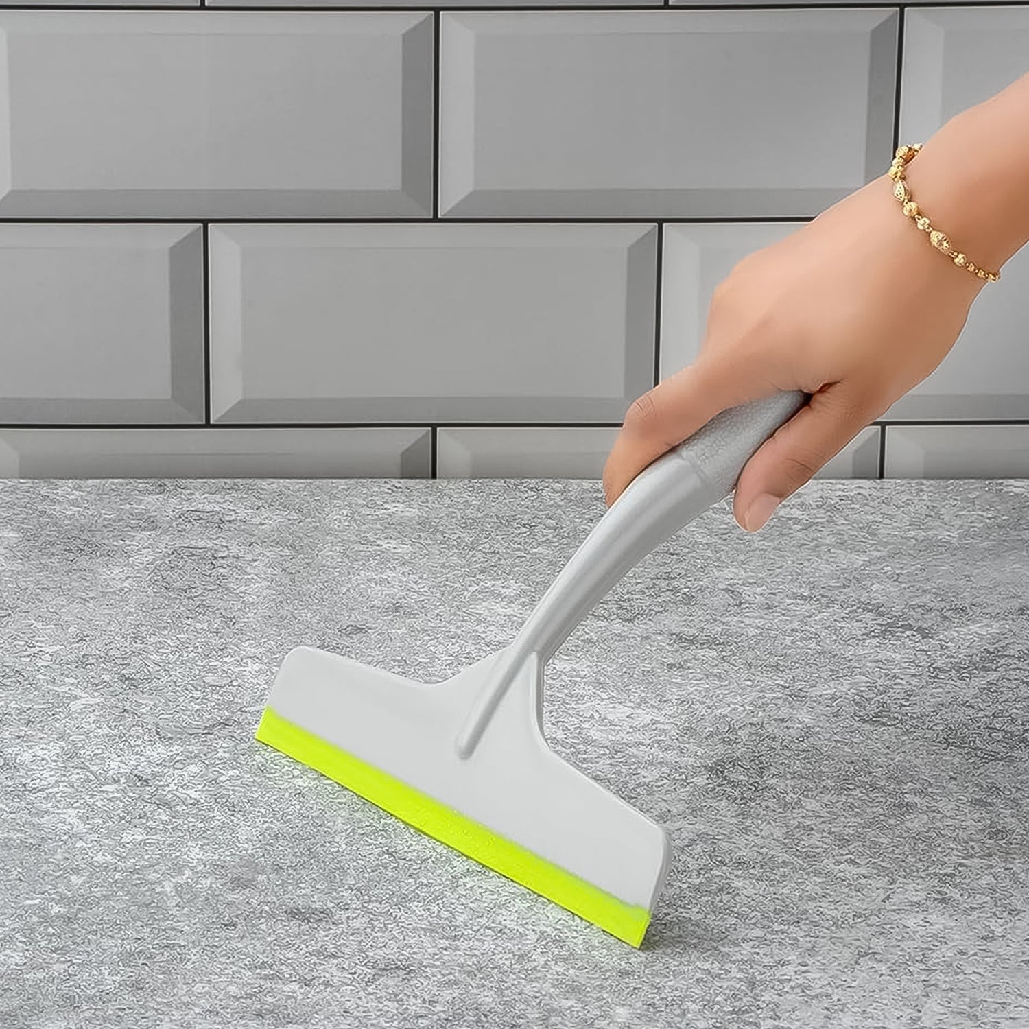Kitchen wiper effectively cleaning a glass surface, leaving it spotless.