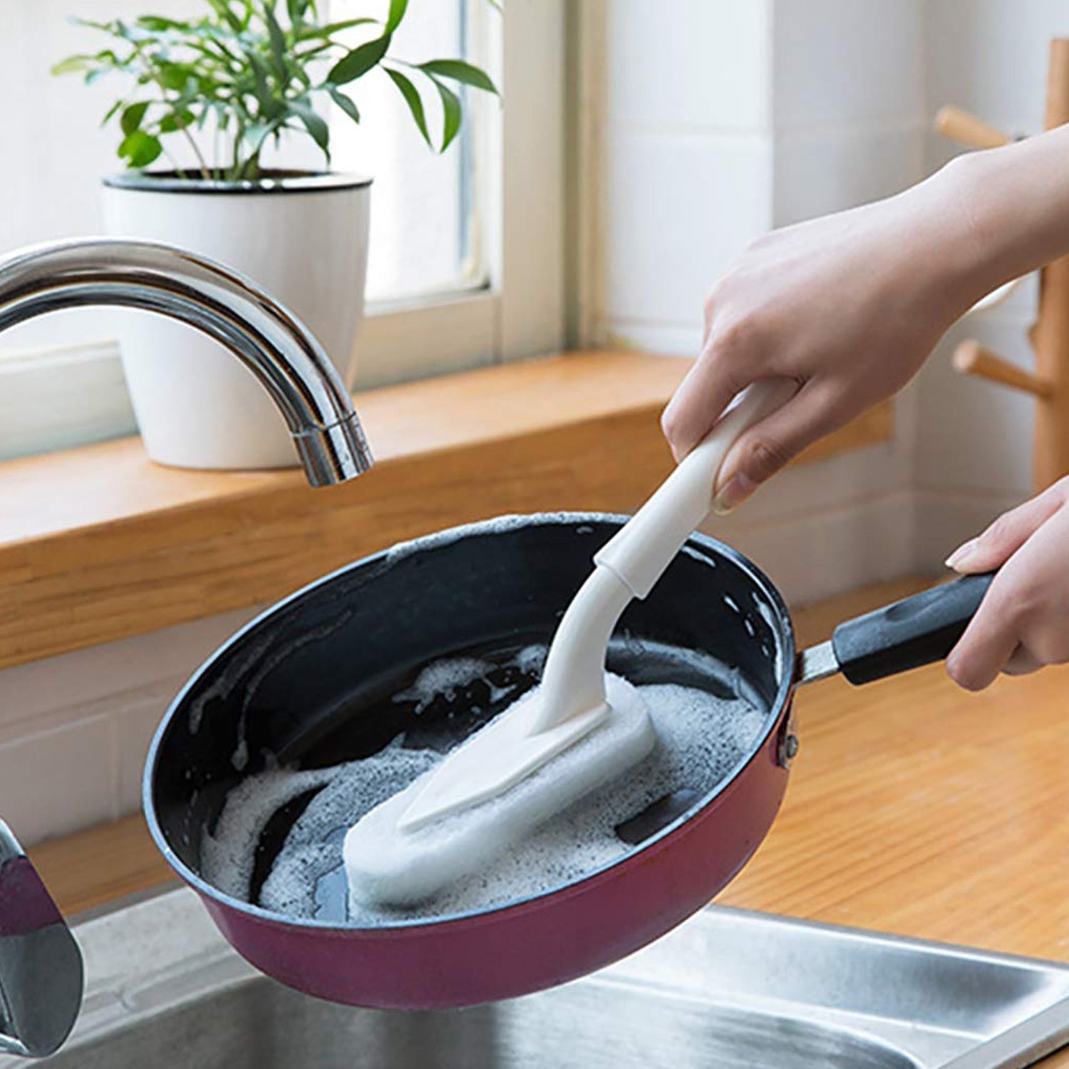 Ergonomic triangle cleaning brush with a detachable sponge head for kitchen and bathroom.