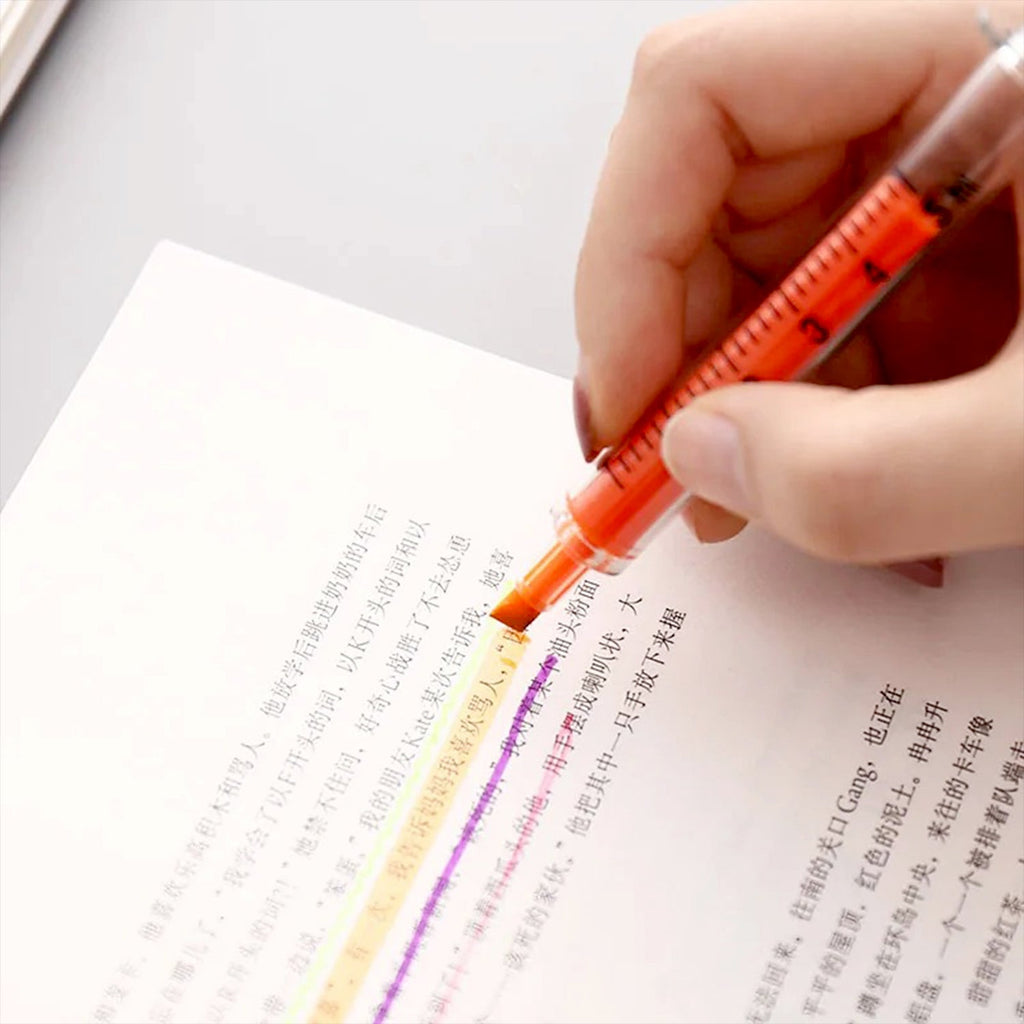 Close-up of the wide tip of a vibrant fluorescent highlighter pen, showing smooth ink flow.