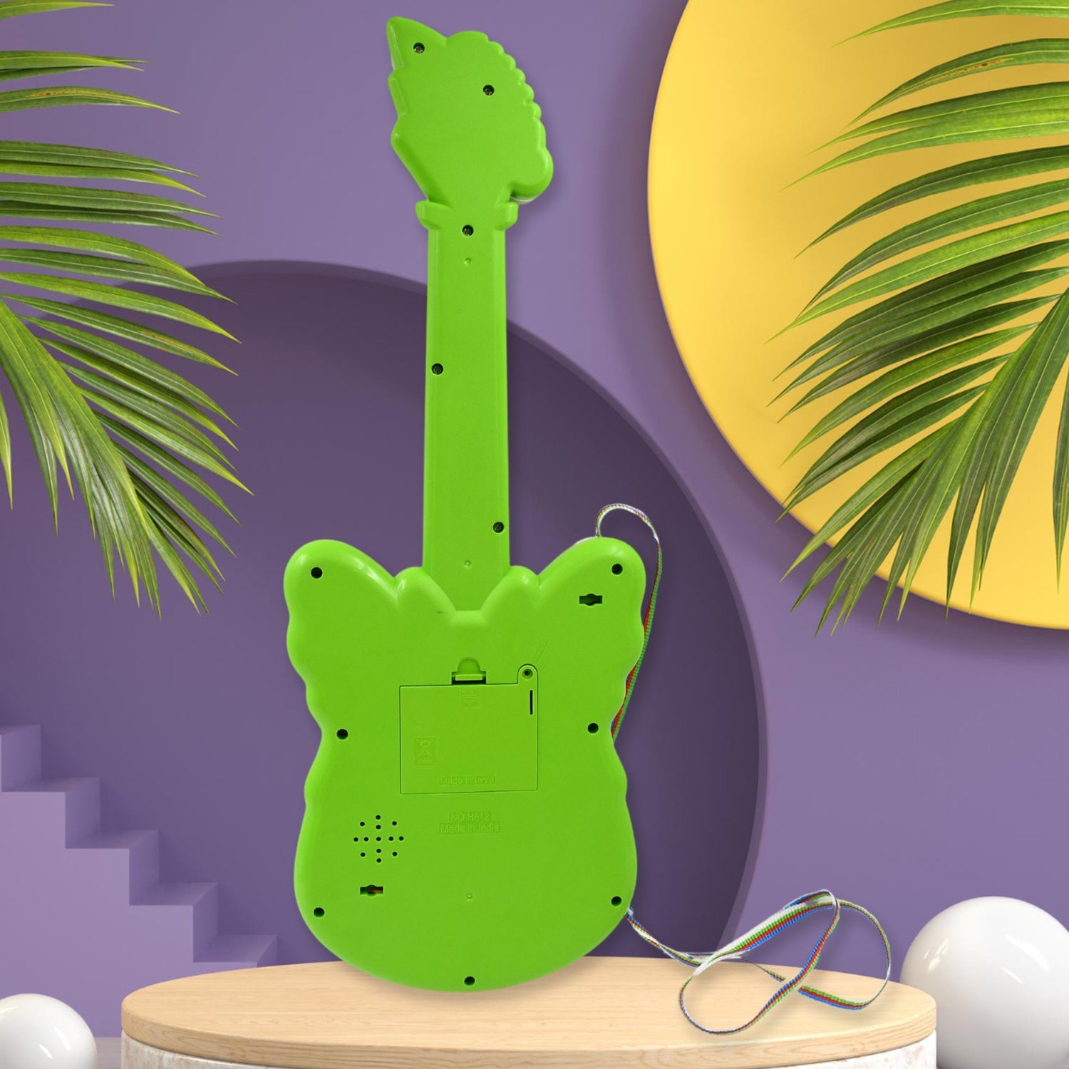 Toddler pressing keys on the butterfly shaped musical guitar toy.