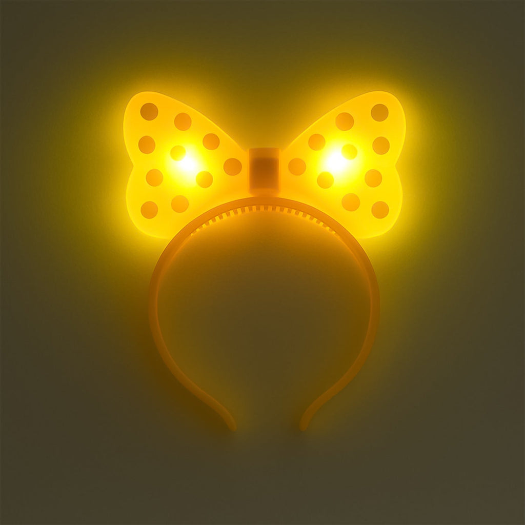 Side view of LED glowing bow hairband on white background