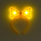 Side view of LED glowing bow hairband on white background