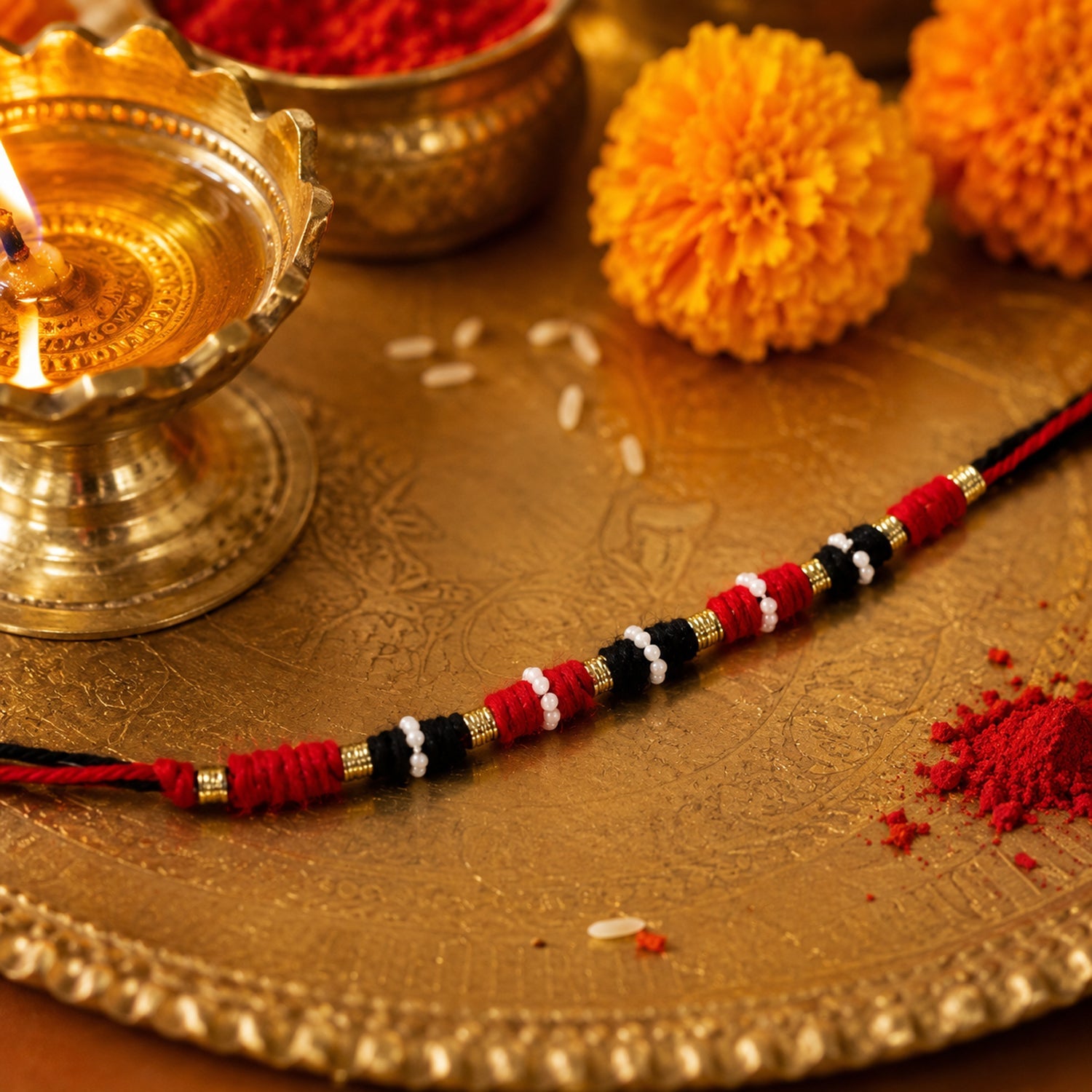 Red black and gold wire rakhi with white beads for Raksha Bandhan