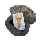 Safelix fake rock key hider blending into an outdoor garden landscape.