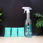 Refill kit sachets dissolving in water to create glass cleaning solution.
