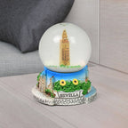Side view of the decorative snow globe, emphasizing its compact and elegant form.