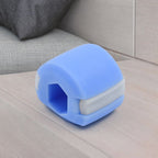 Close-up of the blue jawline exerciser, demonstrating its compact size and grip.