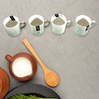 An overhead view of the Serve Stellar 6-piece serving set, emphasizing the coordinated design of the ceramic cups and plastic platter.