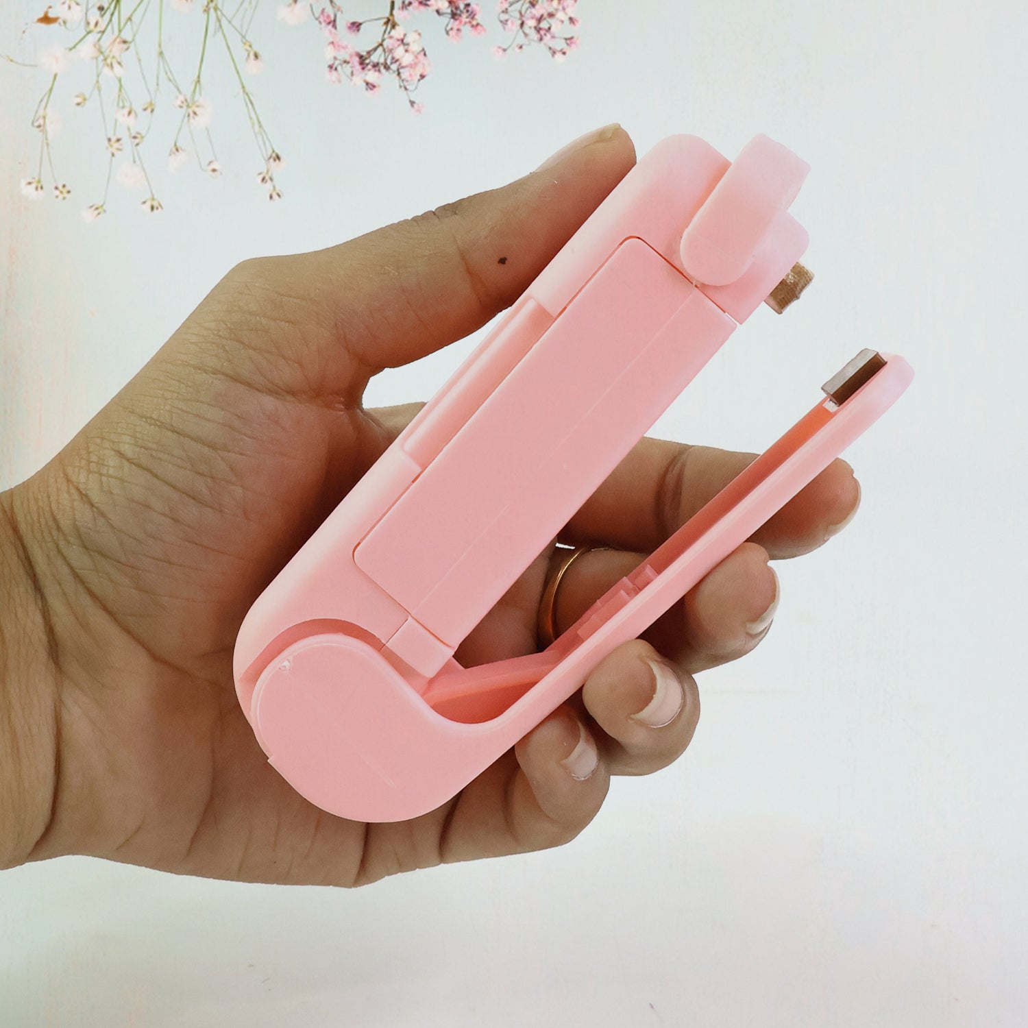 Person demonstrating the quick and easy sealing process with the Mini Plastic Bag Sealer.