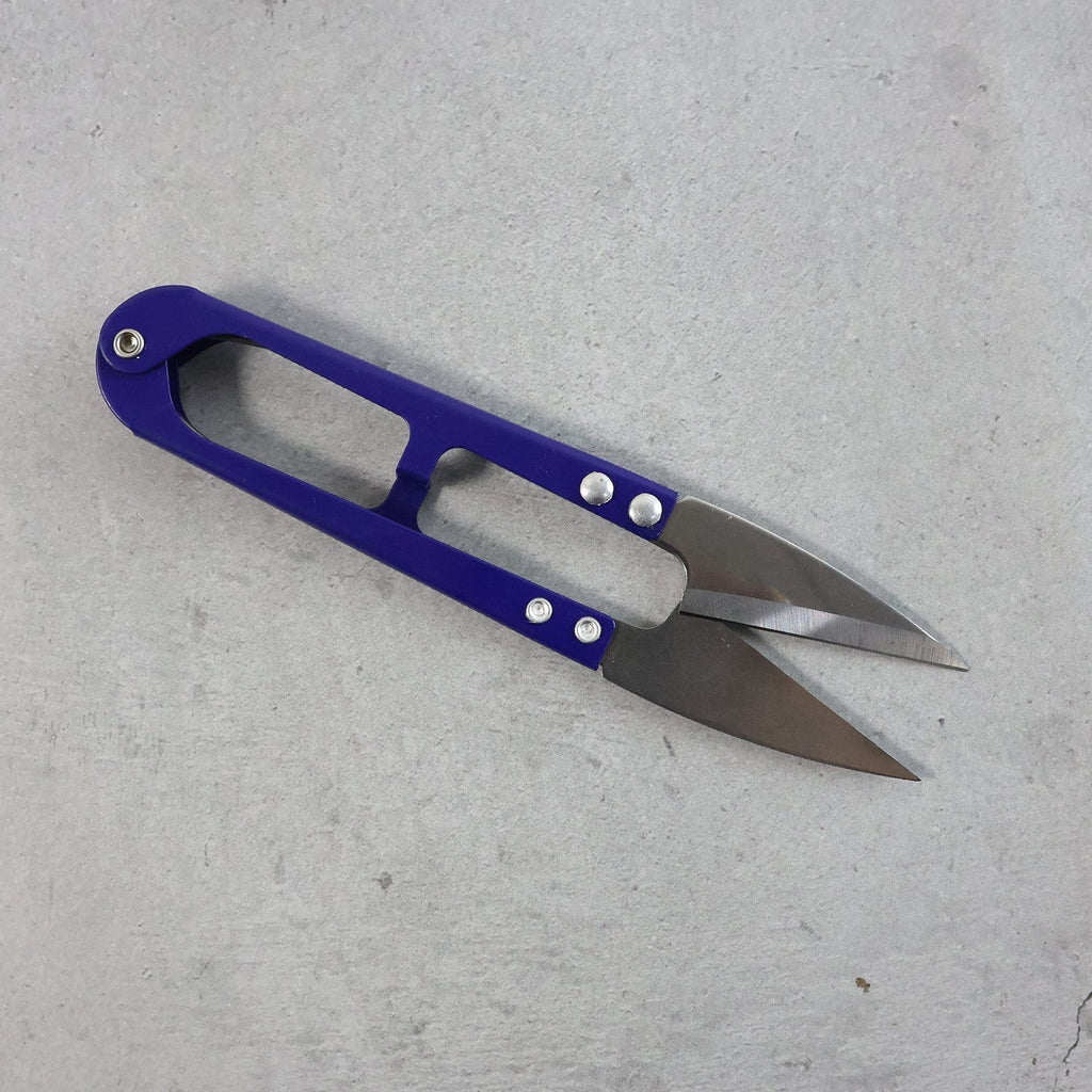 Close-up view of sharp stainless steel blades on sewing scissors