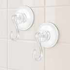 Four plastic suction cup hooks arranged for hanging items