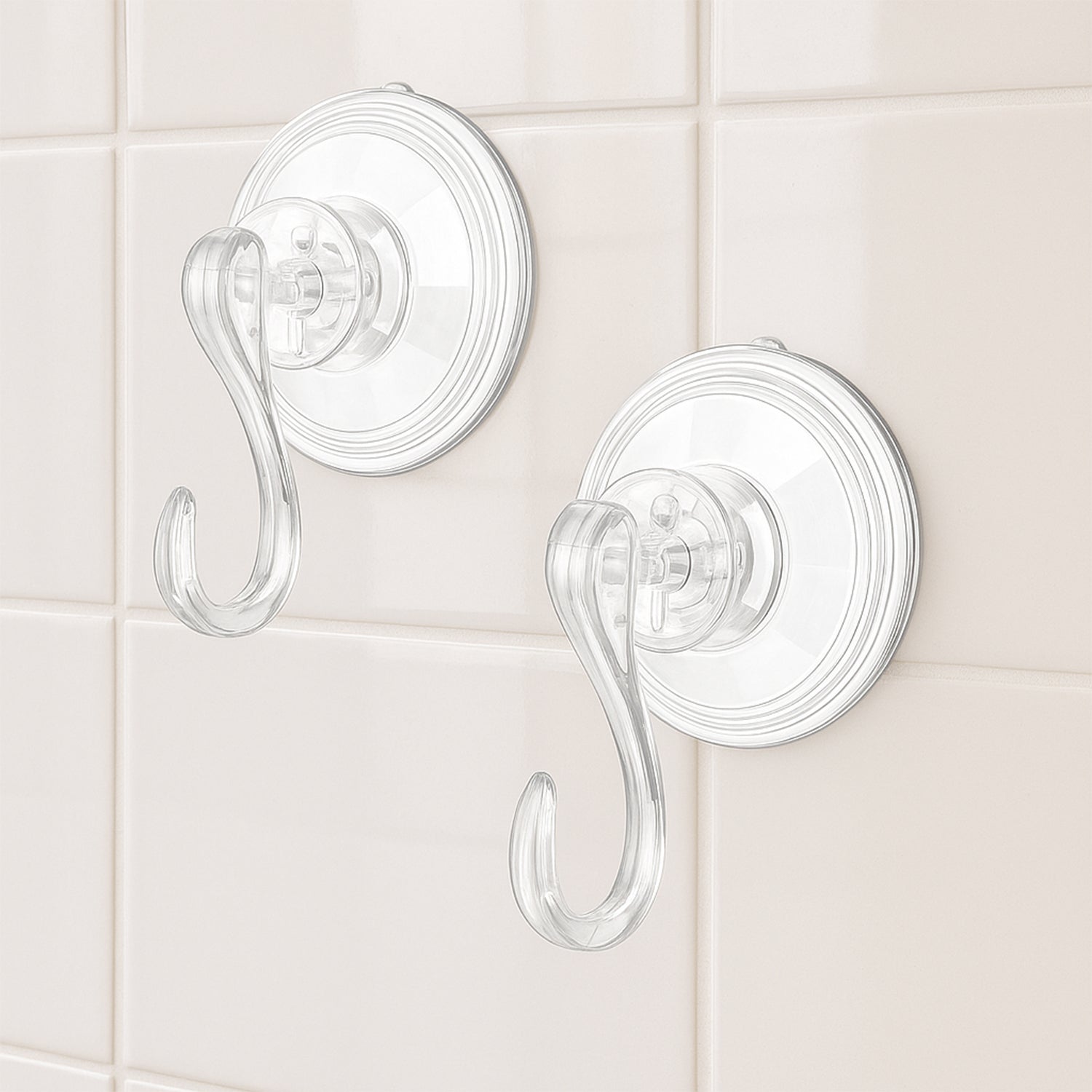 Four plastic suction cup hooks arranged for hanging items