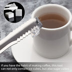 Stainless steel ice cube tongs in a kitchen setting, ready for use.