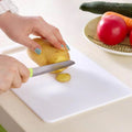 Large plastic chopping board for hygienic kitchen food preparation.