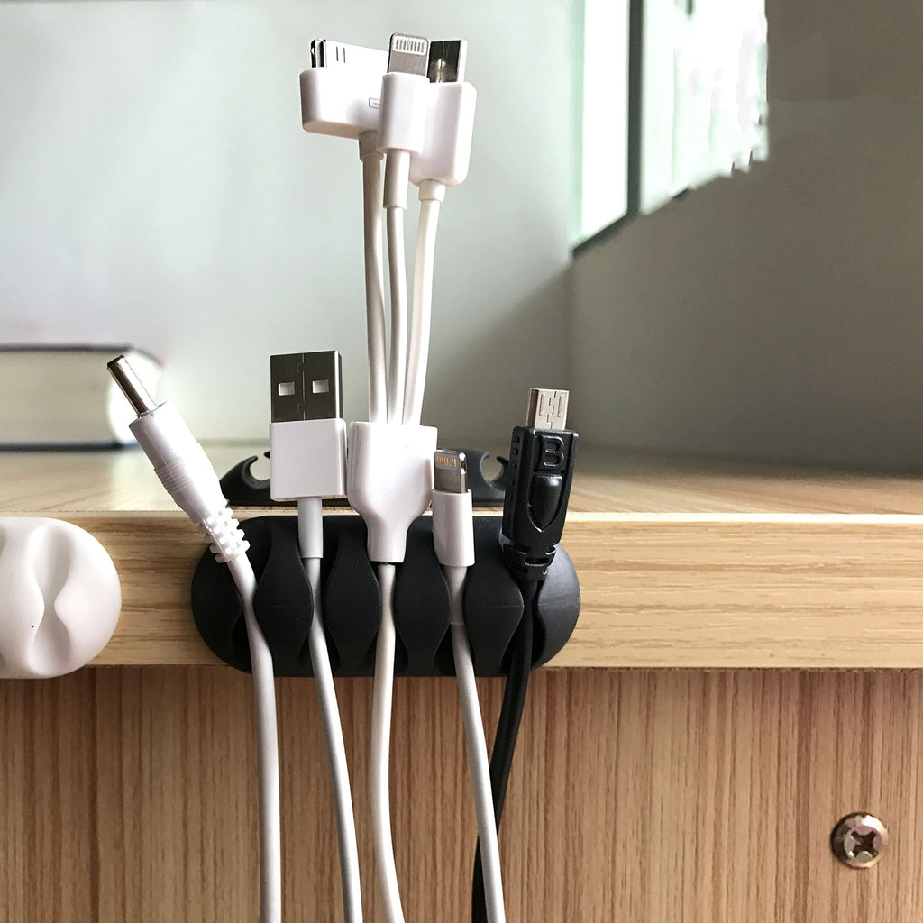 Cable clips organizing multiple wires on a modern wooden desk.