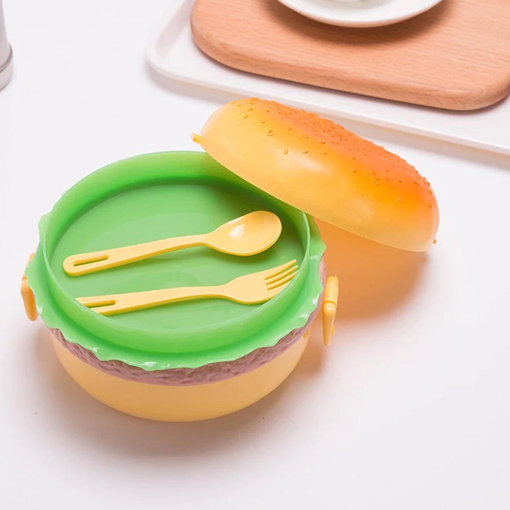 A closed burger shape lunch box, ready for school meals.