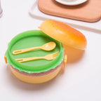 A closed burger shape lunch box, ready for school meals.