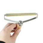 Lint remover with wooden handle shown effectively cleaning pet hair from a beige carpet.