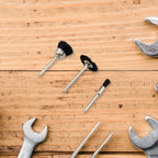 T-shaped brass wire wheel effectively removing stubborn rust from a metal surface.
