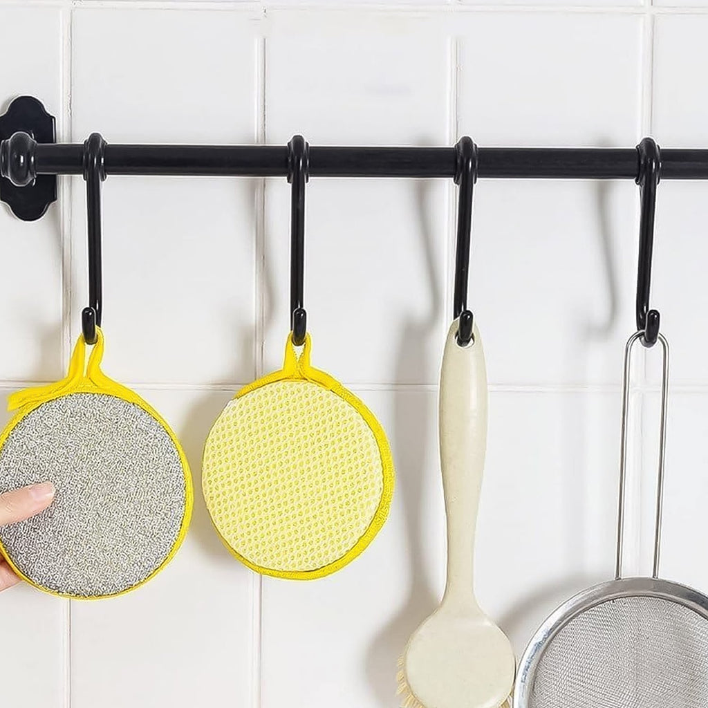 Close-up image of double-sided kitchen cleaning dishwashing sponge brush
