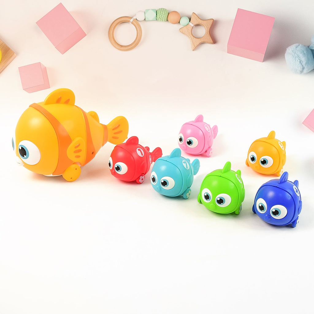 Child holding hook catching fish in magnetic fishing toy set