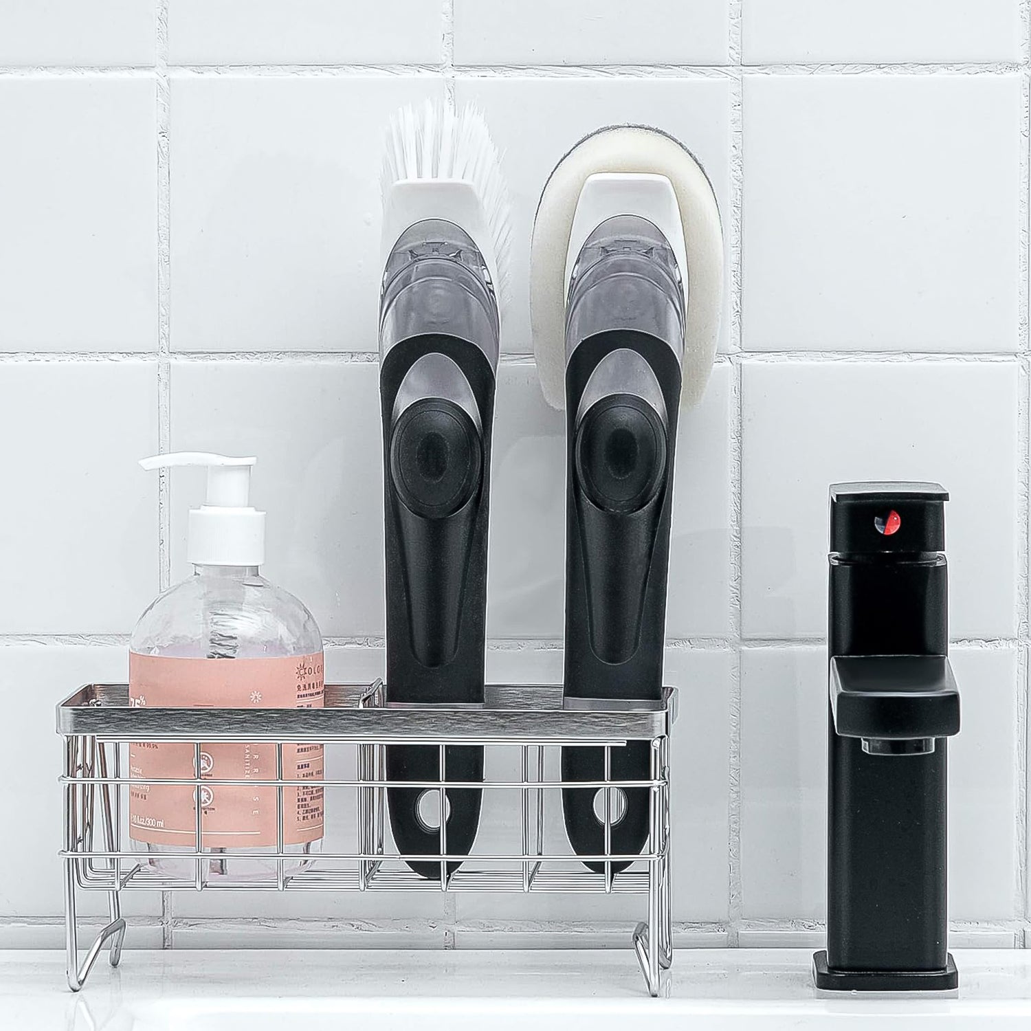 The complete soap dispensing dish brush set, showing the handle and two replacement heads.
