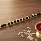 Handcrafted black and white beaded thread rakhi