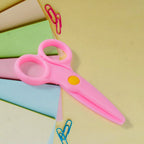 Child-safe plastic scissors featuring an ergonomic handle for small toddler hands.