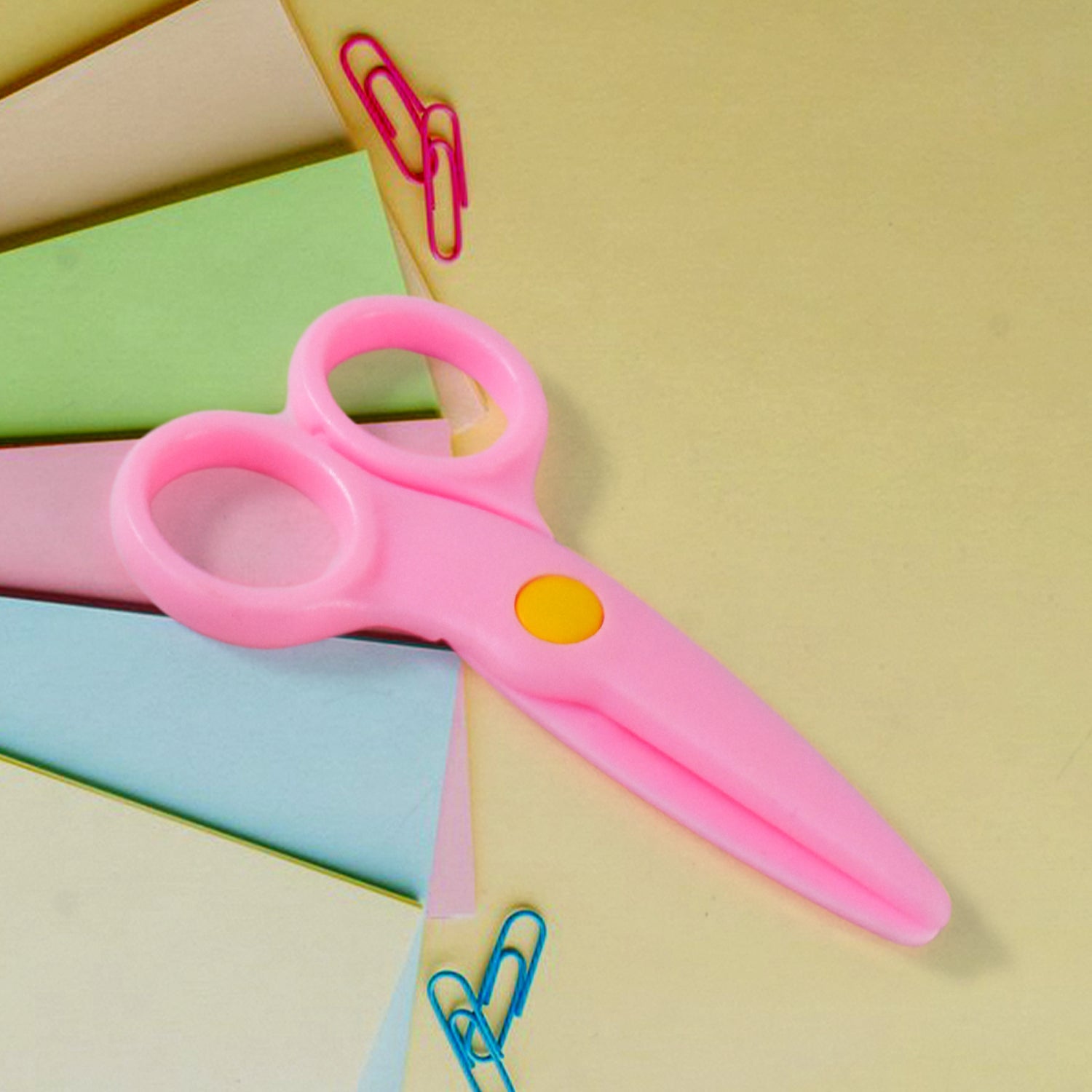Child-safe plastic scissors featuring an ergonomic handle for small toddler hands.