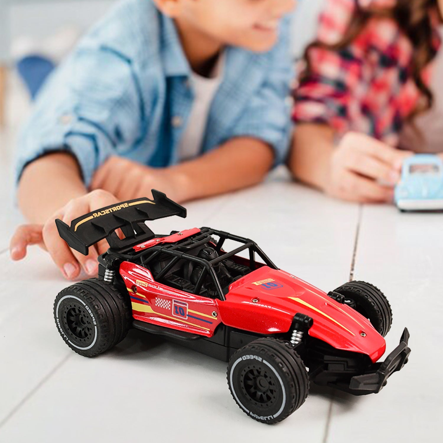 Red RC race car showing action shot on rough terrain for kids