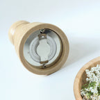 Traditional wooden pepper grinder featuring hand twist mechanism for freshness