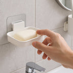 Self adhesive soap holder tray with open slot drainage design