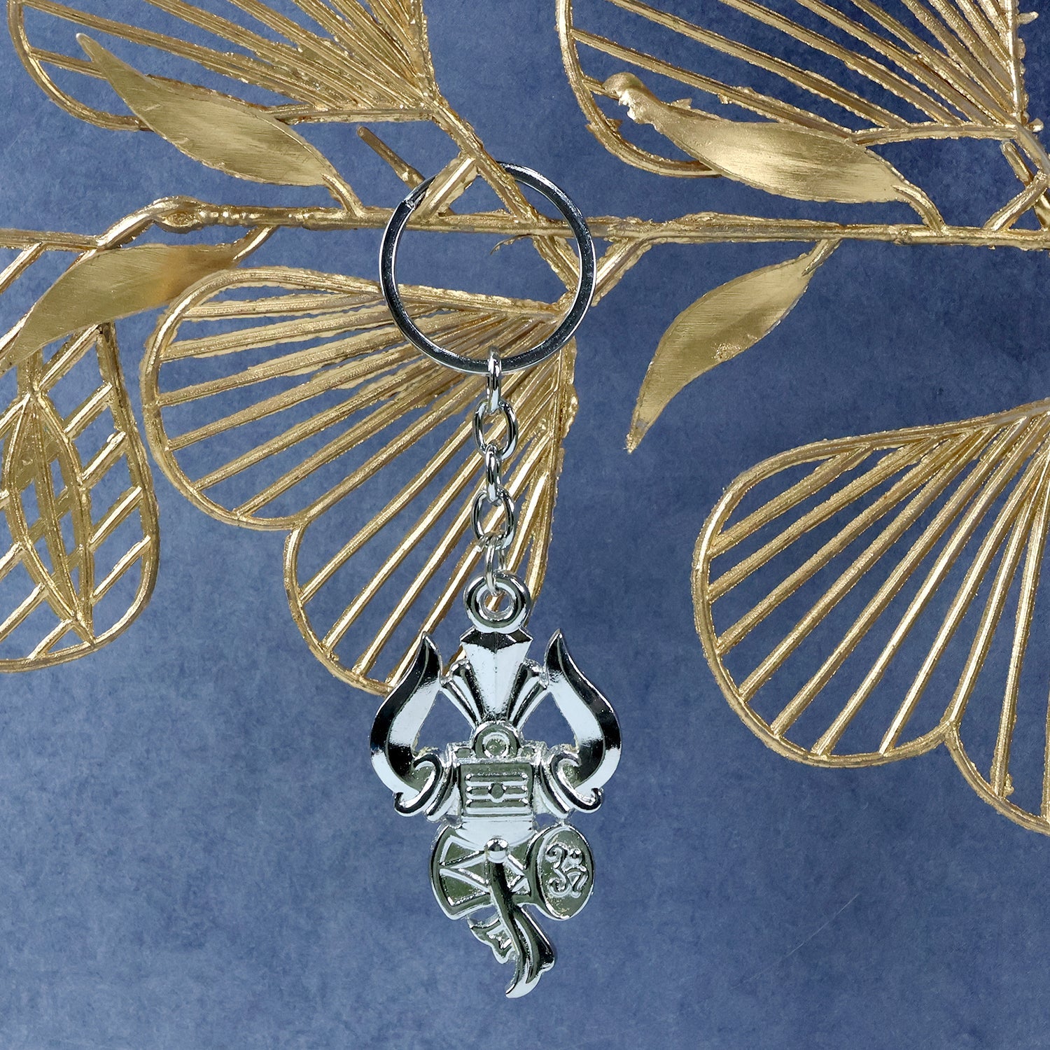 Side angle view of silver Trishul Damru keychain highlighting craftsmanship