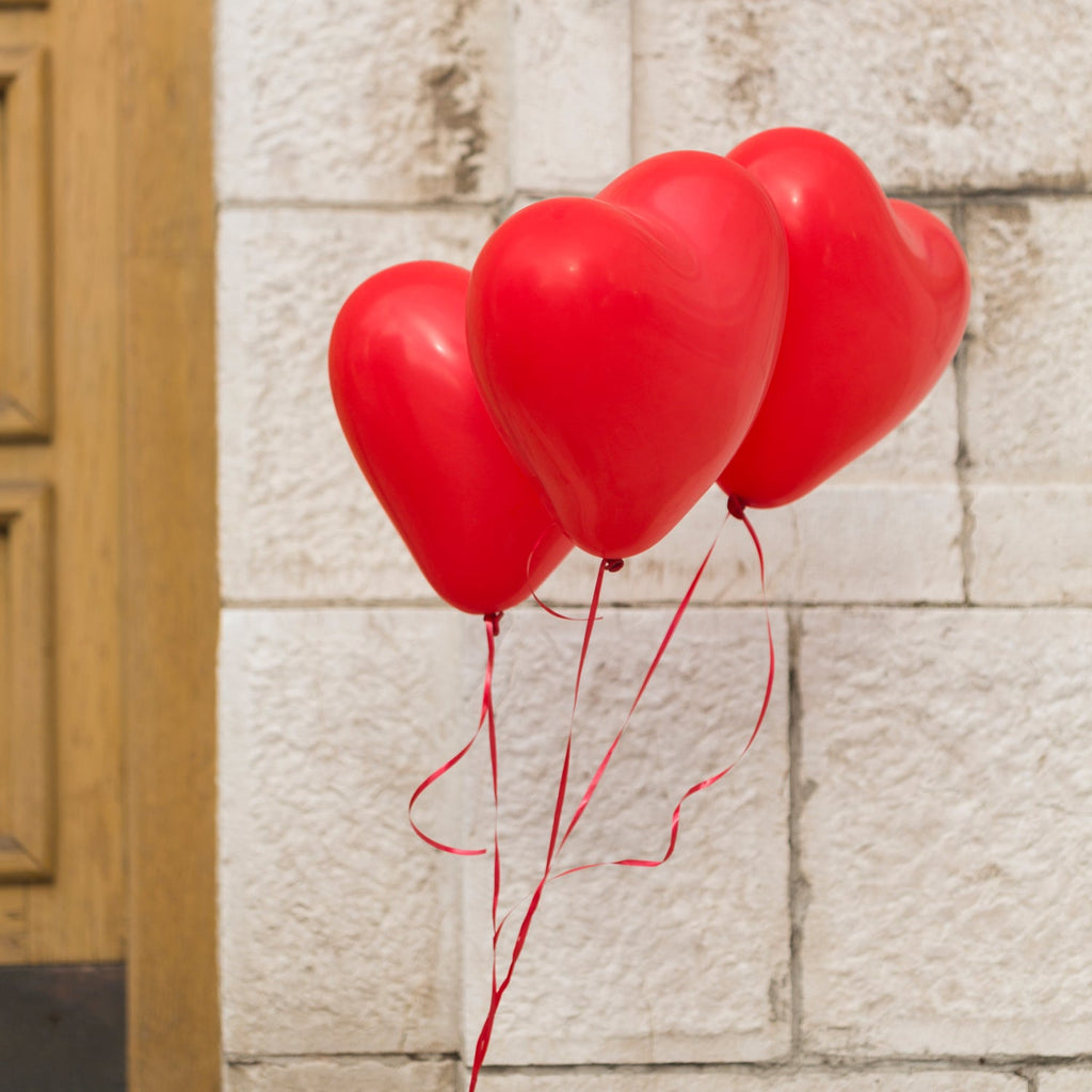 Vibrant heart shaped balloons set in latex for festive Indian celebrations.