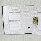 Multiple button clip box files stacked neatly for storage.