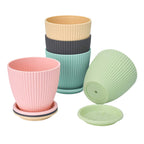 The five-piece plastic flower pot set securely packaged in a brown box for safe shipping.