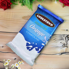 Rich orange chocolate compound texture, ready for melting.