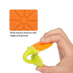 Infant's hand holding a textured fruit teether, promoting fine motor skills.