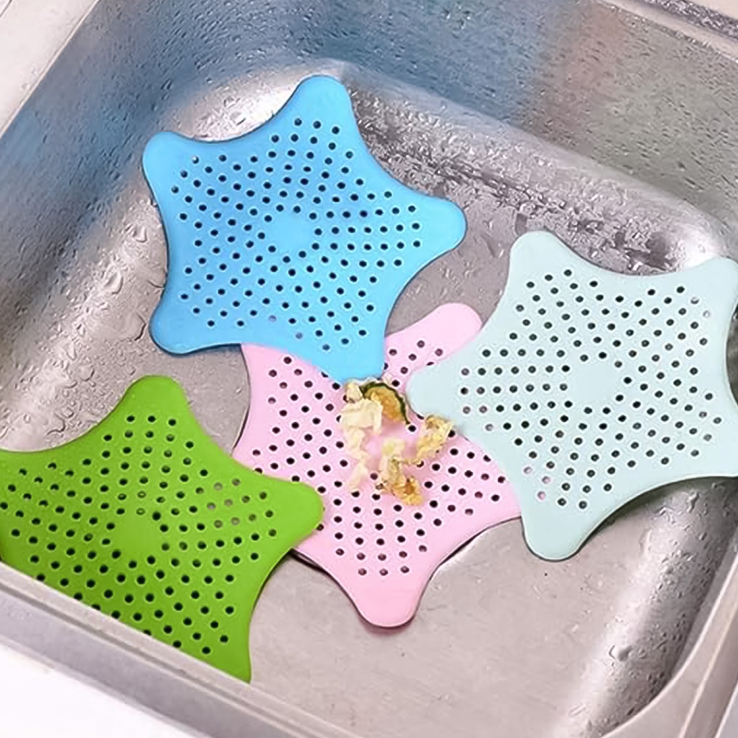 Star-shaped silicone hair catcher actively collecting hair in a bathroom basin.